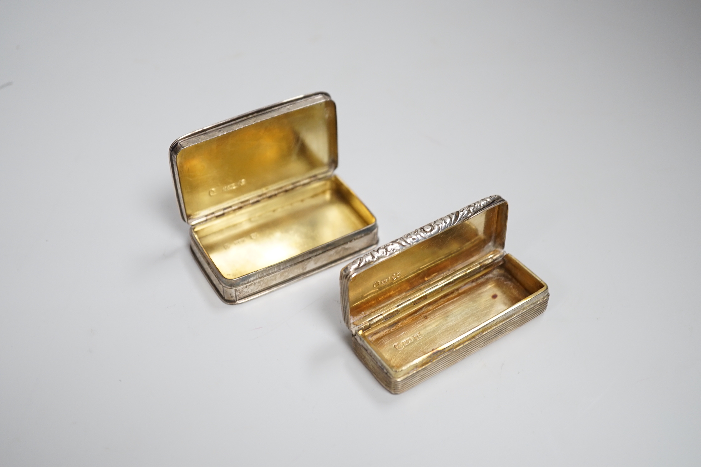 A George IV engine turned silver snuff box, with foliate scroll thumbpiece and banding, maker ES, Birmingham 1825, 6.75cm, 68 grams and a Nathaniel Mills engine turned snuff box, Birmingham 1827, 6.75cm, 60 grams